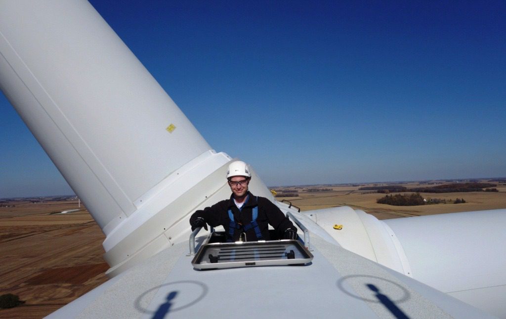 Ross Koehler on top of wind turbine